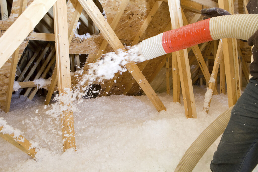 Blown-in insulation being installed in an attic space